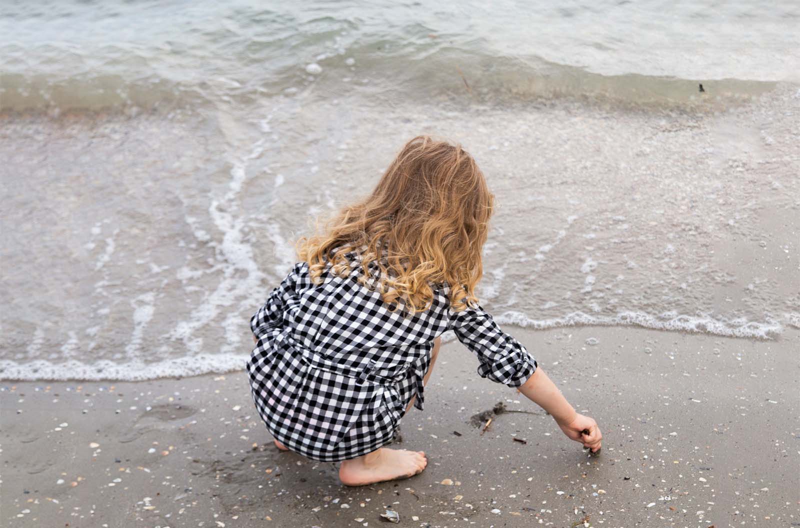 girl in gingham on the beach